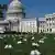 White clog shoes sit outside the US Capitol to honor the nurses who have died from COVID-19