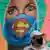 Граффити, изображающие женщину-врача в хирургической шапочке и маске Супермена