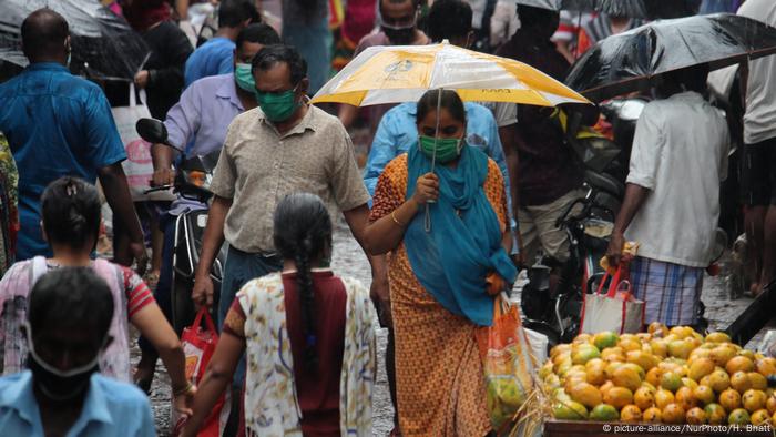 Shoppers during heavy rains in a Mumbai market