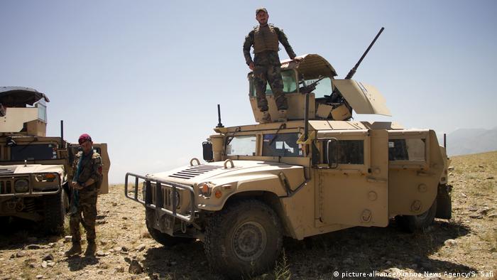 Afghan soldiers stand by military vehicles in eastern Afghanistan