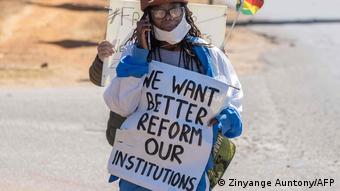 Novelist Dangarembga holding up a sign at a protest in July 2020.