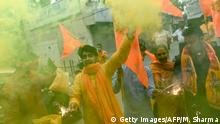 Bharatiya Janata Party (BJP) activists and supporters burn crackers and wave flags as they celebrate before the groundbreaking ceremony of the Ram Temple in Ayodhaya, in New Delhi on August 5, 2020. - India's Prime Minister Narendra Modi will lay the foundation stone for a grand Hindu temple in a highly anticipated ceremony on August 5 at a holy site that was bitterly contested by Muslims, officials said. The Supreme Court ruled in November 2019 that a temple could be built in Ayodhya, where Hindu zealots demolished a 460-year-old mosque in 1992. (Photo by Money SHARMA / AFP) (Photo by MONEY SHARMA/AFP via Getty Images)