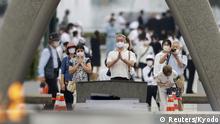 People wearing protective face masks pray for atomic bomb victims in front of the cenotaph for the victims of the U.S. 1945 atomic bombing, at Peace Memorial Park in Hiroshima, western Japan, August 6, 2020, on the 75th anniversary of the atomic bombing of the city. Mandatory credit Kyodo/via REUTERS ATTENTION EDITORS - THIS IMAGE WAS PROVIDED BY A THIRD PARTY. MANDATORY CREDIT. JAPAN OUT. NO COMMERCIAL OR EDITORIAL SALES IN JAPAN.