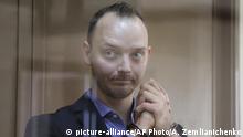 Ivan Safronov, an adviser to the director of Russia's state space corporation, stands in a cage in a courtroom in Moscow, Russia, Thursday, July 16, 2020. Safronov, who rose to prominence as a journalist writing about Russia's defense industry, was arrested earlier this month on treason charges. The case against Safronov has elicited outrage and is seen by many as retaliation for his work as a journalist. (AP Photo/Alexander Zemlianichenko) |