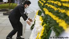 Japan's Prime Minister Shinzo Abe wearing a protective face mask, offers a wreath to the cenotaph for the victims of the 1945 atomic bombing, at Peace Memorial Park in Hiroshima, western Japan, August 6, 2020, on the 75th anniversary of the atomic bombing of the city. Mandatory credit Kyodo/via REUTERS ATTENTION EDITORS - THIS IMAGE WAS PROVIDED BY A THIRD PARTY. MANDATORY CREDIT. JAPAN OUT. NO COMMERCIAL OR EDITORIAL SALES IN JAPAN.