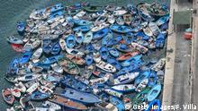 LAMPEDUSA, ITALY - AUGUST 04: Aerial view of boats and inflatables used by migrants disembarked in recent days in Lampedusa and abandoned in the port of the island waiting to be demolished on August 04, 2020 in Lampedusa, Italy. The Italian island has reportedly run out of room to quarantine migrants, as is required as part of Italy's anti-coronavirus measures. (Photo by Fabrizio Villa/Getty Images)