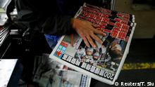An employee takes copies of the Apple Daily newspaper, published by Next Media Ltd, with a headline Apple Daily will fight on after media mogul Jimmy Lai Chee-ying, founder of Apple Daily was arrested by the national security unit, at the company's printing facility, in Hong Kong, China August 11, 2020. REUTERS/Tyrone Siu TPX IMAGES OF THE DAY