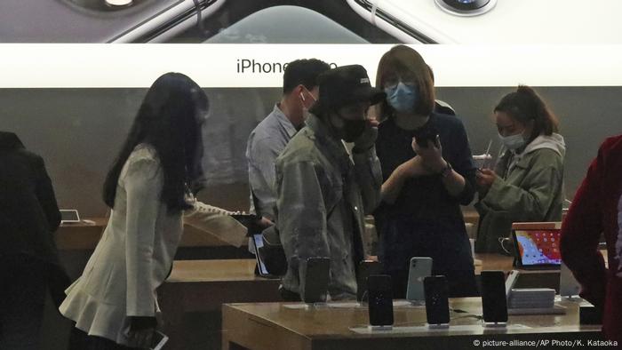 People wearing face mask go out for shopping at Apple Store of a commercial complex in Sanlitun, Beijing