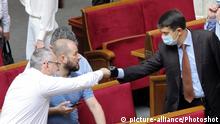 KYIV, UKRAINE - JULY 15, 2020 - Speaker Dmytro Razumkov (C) bumps fists with his colleague during a sitting of the Verkhovna Rada, Kyiv, capital of Ukraine. Regular local elections will take place in Ukraine on October 25, 2020. Some 326 MPs voted for the decision. |