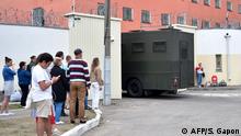 Relatives and friends of detained participants of recent opposition rallies gather outside a detention centre in Minsk on August 12, 2020. - Police in Belarus said on August 12 they had detained hundreds more people and used firearms against protesters in a third night of violence over a disputed presidential election. (Photo by Sergei GAPON / AFP)