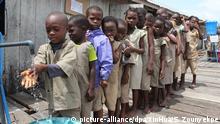 ARCHIV - 17.10.2019, Benin, Cotonou: Schüler der Toyoyome-Grundschule stellen sich vor dem Mittagessen in eine Schlange, um sich die Hände zu waschen. In vielen Schulen auf der Welt haben die Kinder keine Chance, sich die Hände zur Vorbeugung gegen eine Corona-Infektion zu waschen. Laut Weltgesundheitsorganisation (WHO) und dem Kinderhilfswerk Unicef gibt es in 43 Prozent der Schulen keinen Zugang zu Waschbecken mit Seife und fließend Wasser. (zu dpa WHO und Unicef: In vielen Schulen ist Händewaschen nicht möglich) Foto: Seraphin Zounyekpe/XinHua/dpa +++ dpa-Bildfunk +++