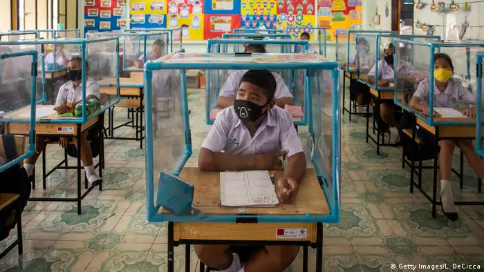 Thai students wear face masks and sit at desks with plastic screens (Getty Images/L. DeCicca)
