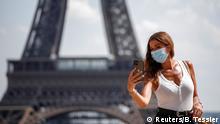 FILE PHOTO: A woman wears a protective face mask at the Trocadero square near the Eiffel Tower in Paris as France reinforces mask-wearing as part of efforts to curb a resurgence of the coronavirus disease (COVID-19) across the country, August 9, 2020. REUTERS/Benoit Tessier/File Photo