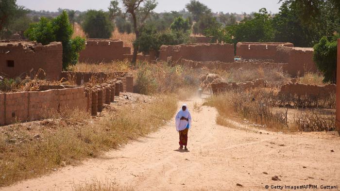 A Burkinabe woman observes the passage of the French Army