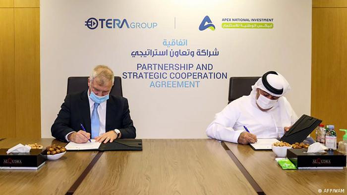A handout image provided by the United Arab Emirates News Agency (WAM) on August 16, 2020, shows representatives from the Emirati company APEX National Investment (R) and the Israeli TeraGroup, signing an agreement to develop research on the novel coronavirus, in the Emirati capital Abu Dhabi