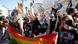 Pro-LGBT+ protesters gesture in a standoff with nationalists in Warsaw Pro-LGBT+ protesters gesture in a standoff with nationalists in Warsaw