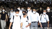 People wearing face mask are seen during commuting time at Shinagawa Station in Minato Ward, Tokyo on August 18, 2020, amid continuing worries over the new coronavirus COVID-19. ( The Yomiuri Shimbun via AP Images ) |