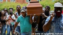 Friends and relatives carry the coffin of one of five youngsters found murdered in a sugar cane field during their funeral in Aguablanca district, in the east of Cali, Colombia, on August 13, 2020. - Over 460 murders were registered in Cali from January to June 2020 according to an official report. (Photo by Luis ROBAYO / AFP) (Photo by LUIS ROBAYO/AFP via Getty Images)