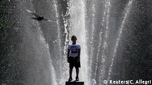 1a.08.2020+++ A child plays in a fountain in Washington Square Park as a pigeon flies past in the Manhattan borough of New York City, New York, U.S., August 18, 2020. REUTERS/Carlo Allegri 