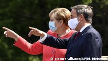German chancellor Angela Merkel, left, wears a face mask due to the coronavirus pandemic as she meets Governor Armin Laschet, right, during her visit at Germany's most populated federal state North Rhine-Westphalia in Duesseldorf, Germany, Tuesday, Aug. 18, 2020. (AP Photo/Martin Meissner) |