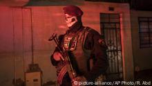 A police officer stands guard as he enforces curfew due to the new coronavirus pandemic, in El Callao, on the outskirts of Lima, Peru, Wednesday, April 8, 2020. (AP Photo/Rodrigo Abd). |