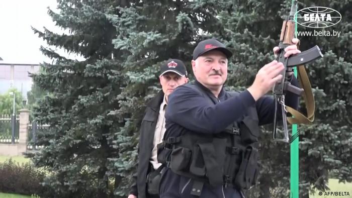 President Alexander Lukashenko holding an automatic rifle and wearing body armour as he arrives, on August 23, 2020, at his residence in Minsk