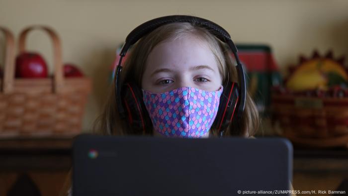 Girl in front of screen with mask