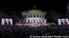 Invited guests watch former New York City Mayor Rudy Giuliani on video screens before President Donald Trump speaks from the South Lawn of the White House on the fourth day of the Republican National Convention, Thursday, Aug. 27, 2020, in Washington. (AP Photo/Evan Vucci) | 