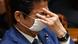 Japan's Prime Minister Shinzo Abe adjusts his face mask during an upper house budget committee session at the parliament in Tokyo on April 30, 2020 Japan's Prime Minister Shinzo Abe adjusts his face mask during an upper house budget committee session at the parliament in Tokyo on April 30, 2020