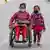 Shanti tamang, aged 32, in a wheelchair with her child, Rima tamang moving along a deserted road while wearing face masks as a precaution during lockdown