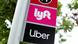 Lyft and Uber logos on a sign Lyft and Uber logos on a sign