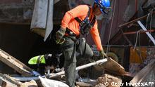 A Chilean rescue worker and a dog search for victims through the rubble of a building that collapsed in the August 4 explosion at the nearby Beirut seaport, in the Lebanese capital's neighbourhood of Gemayzeh, on September 2, 2020. - Hundreds of tonnes of ammonium nitrate, a highly explosive fertiliser, exploded at Beirut's port on August 4 this year causing severe damage across swathes of the Lebanese capital as well as killing and injuring scores of people. (Photo by - / AFP) (Photo by -/AFP via Getty Images)