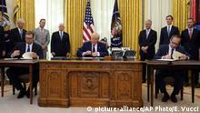 President Donald Trump participates in a signing ceremony with Serbian President Aleksandar Vucic, seated left, and Kosovar Prime Minister Avdullah Hoti, seated right, in the Oval Office of the White House, Friday, Sept. 4, 2020, in Washington. (AP Photo/Evan Vucci) |