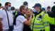 A protester faces off against a police officer A protester faces off against a police officer