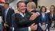 Gerhard Schröder and Vladimir Putin hugging Gerhard Schröder and Vladimir Putin hugging