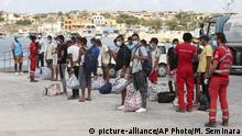 Sept. 5 , 2020***
Migrants wait to board a coast guard ship that will take them to the GNV Rhapsody ferry moored off Lampedusa island, Italy, Saturday, Sept. 5 , 2020. Italian officials have been hastily chartered ferries and put other measures into place to fight severe overcrowding at migrant centers on the tiny island of Lampedusa. (AP Photo/Mauro Seminara) |
