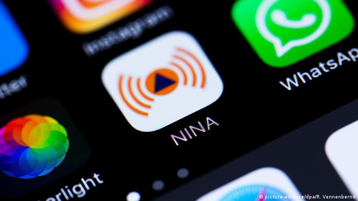 A picture of the NINA app icon on a smartphone