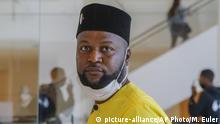 Congo-born Mwazulu Diyabanza arrives at the courthouse to contest the bans imposed on him that prevent him from leaving France and from visiting the Quai Branly museum area, in Paris, Wednesday, June 24, 2020. A French court refused Wednesday to lift restrictions placed on a Congolese activist after he dislodged an African funeral pole in a Paris museum. His protest was an effort to demand that France return African art to former colonies. (AP Photo/Michel Euler) |