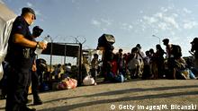 MYTILENE, GREECE - SEPTEMBER 12: Migrants wait to be registered at the refugee camp at Kara Tepe in the northeast of the capitol on the Greek island of Lesbos on September 12, 2020 in Mytilene, Greece. A massive fire ravaged the Moria migrant camp on the night of September 8, leaving more than 12,000 refugees homeless with many being shuttled to newly built tents at Kara Tepe refugee camp to house them. (Photo by Milos Bicanski/Getty Images)