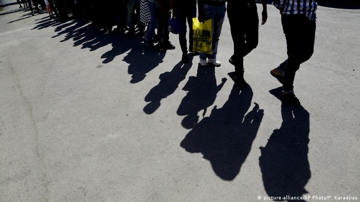 Shadows of refugees are cast on the ground in Cyprus