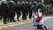 A protester in front of riot police in Minsk A protester in front of riot police in Minsk