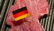 A piece of meat with a small German flag A piece of meat with a small German flag