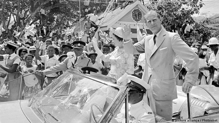 Queen Elizabeth II and Prince Philip wave from a car on a tour of the Caribbean in Barbados, 1966
