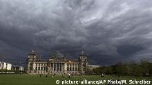 Dark clouds hang over the Reichstag, the German parliament Bundestag building, in Berlin, Tuesday, Aug. 20, 2013. Weather forecasts predict changeable weather in Germany for the next few days. (AP Photo/Markus Schreiber) |