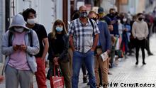 FILE PHOTO: People wait in a line to get tested for the coronavirus disease (COVID-19) before a sampling station opens at Wenceslas Square in Prague, Czech Republic, September 16, 2020. REUTERS/David W Cerny/File Photo