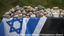 Stones are placed at the Holocaust memorial during the commemoration of the 75th anniversary of the massacre of some 2,000 Jews by Nazi occupiers and their Lithuanian collaborators during World War II in Moletai, Lithuania, Monday, Aug. 29, 2016. More than 90 percent of Lithuania's 240,000 Jews were killed during World War II. The role of local units is sensitive in Lithuania, which mainly views itself as a victim of Nazi and Soviet occupations. (AP Photo/Mindaugas Kulbis) |