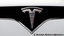 FILE PHOTO: The Tesla logo is seen on a car at Tesla's new showroom in Manhattan's Meatpacking District in New York City, U.S., Dec. 14, 2017. REUTERS/Brendan McDermid/File Photo