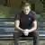 Alexi Navalny sitting on a park bench in Germany