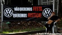 FILE PHOTO: Former Volkswagen worker Raimundo Nonato sits in front of VW factory headquarters during a protest against the presentation of the study of Volkswagen's role in Brazil from 1964 to 1985, in Sao Bernardo do Campo, Brazil December 14, 2017. REUTERS/Paulo Whitaker/File Photo
