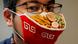 A Japanese designer wears a mask that looks like a ramen bowl A Japanese designer wears a mask that looks like a ramen bowl